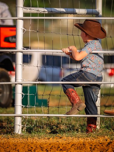 Little Cowboy

This little cowboy was watching in awe as the horses and drill team warm up.