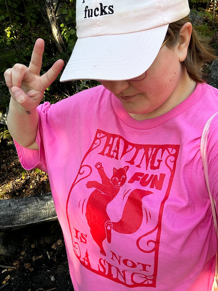 having fun is not a sin red on pink t-shirt product image (1)