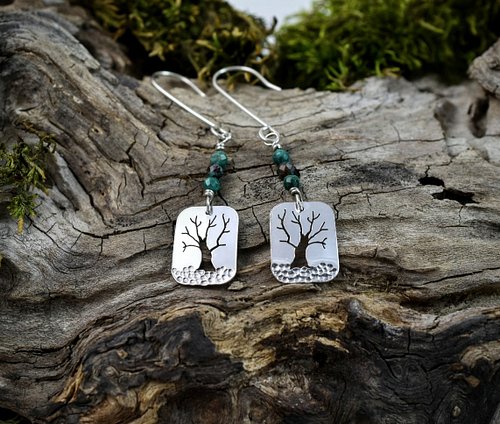 Embodying the essence of nature, these sterling silver tree earrings feature a one-of-a-kind tree cutout design, beautifully ...