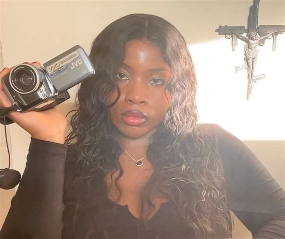 Rapper Francesca Wexler holding a camcorder.