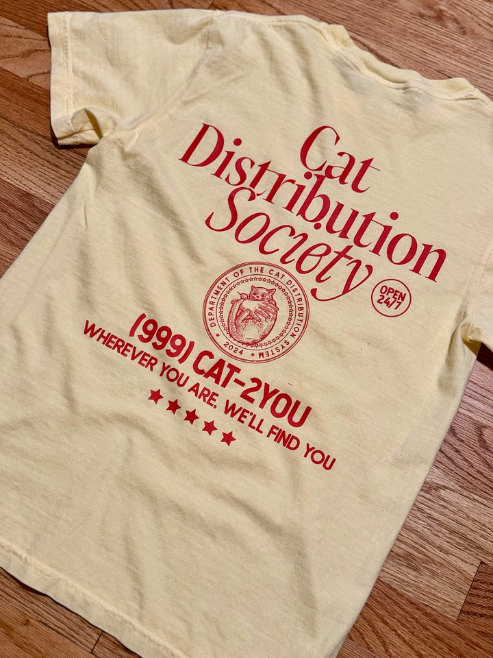 Cat distribution society oversized unisex tee (orange text) product image (1)