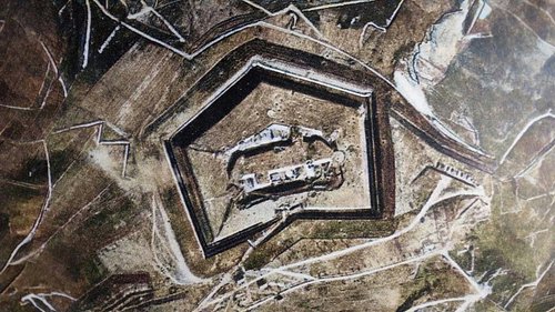 These aerial photographs show the imposing Fort Douaumont before the battle of Verdun, and then after months of fighting in 1...