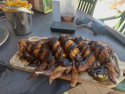 Chicken wings for me, breakfast Focaccia for Lisa. I can confirm the sausage is an elite, top-end catering sausage, very herb...