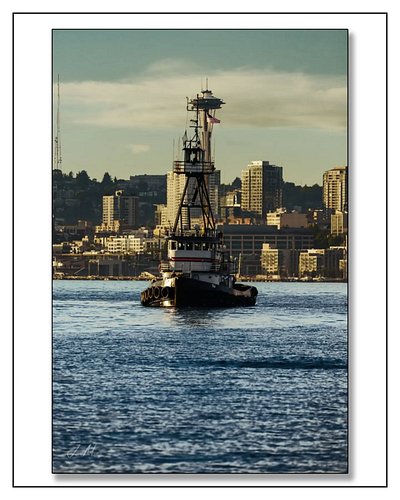 Tug AJ on Elliott Bay with the Space Needle peeking perfectly through her mast. Only in Seattle. 
Www.jasonmosleyphotography....