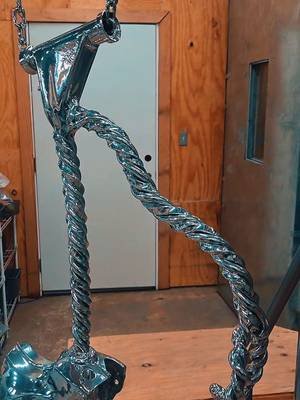 From bare metal to mirror finish!** 🪞✨ We took these custom twisted bars, frame pieces, and components from raw teardown status straight into the powder-coat booth. Seeing that chrome-like finish pop hanging from the chains makes all the prep work worth it. The pieces are curing, looking clean, and getting ready to turn some serious heads. Sturgis bound in eight days!! #CustomBuild #PowderCoat #ChopperFabrication #WorkshopLife #FilthyGringos  