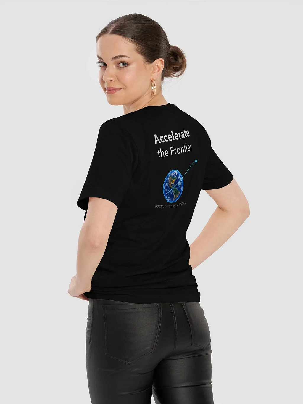 Model wearing the black Frontier Arc Tee, with Accelerate the Frontier lettering and a small blue globe and rising cyan arc on the back.