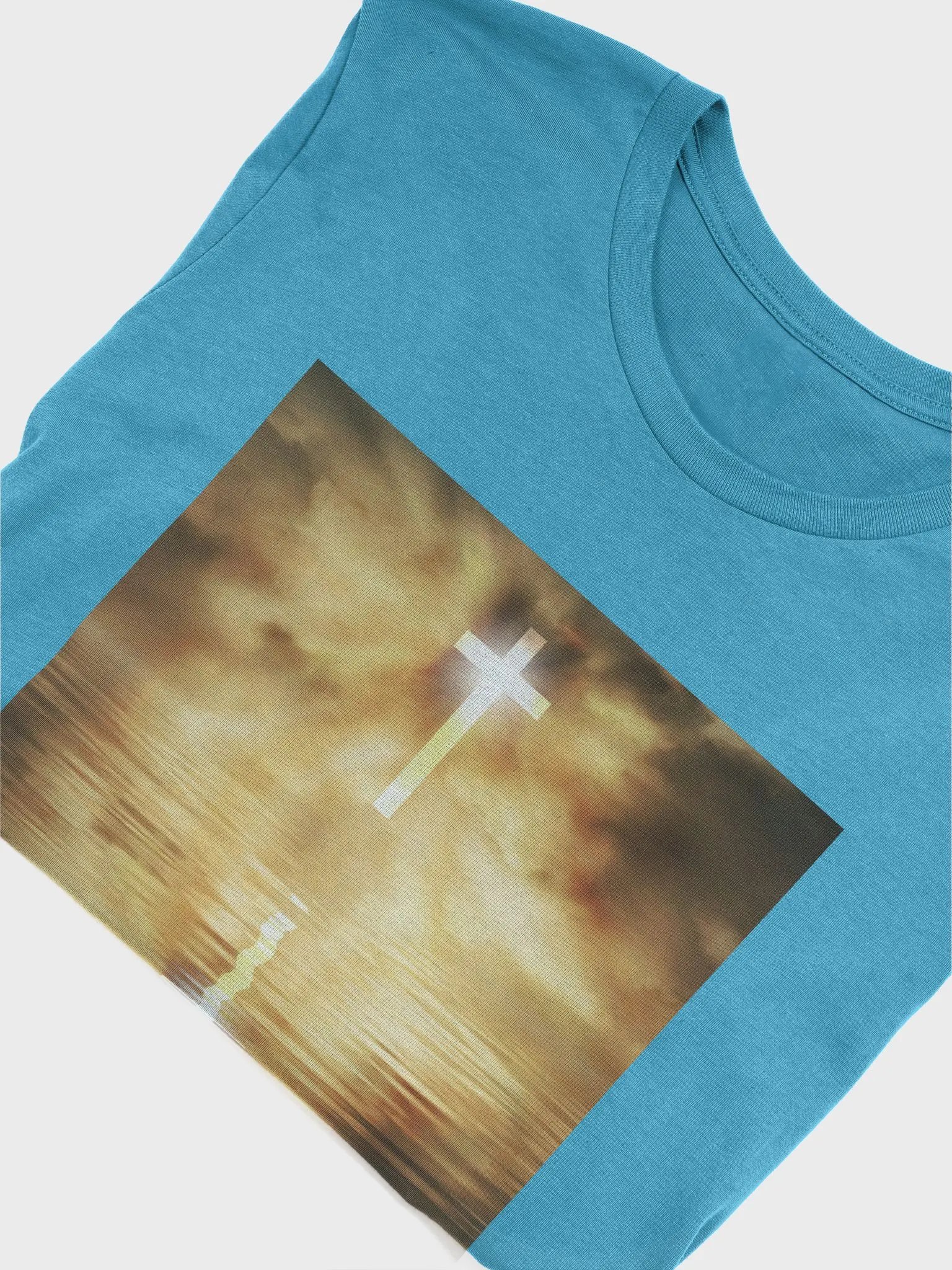 Glowing cross illuminated by intense golden light, reflecting on calm water below t-shirt product image (10)
