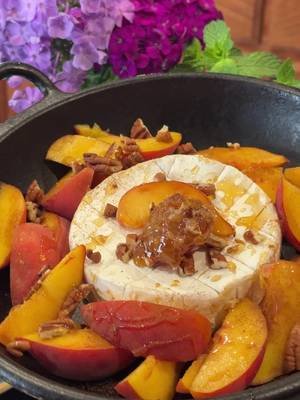 The most delicious summer appetizer. 😍 This is your sign to cook your peaches with honey, cinnamon, and a wheel of brie. 🍑🤤 Grocery partner: @krogerdfw  Cast Iron Peaches and Brie 1 wheel brie  3 peaches 1-2 Tbsp honey Dash of cinnamon Optional: Honeycomb 1 Tbsp pecans Fresh thyme 1) Score brie in a crisscross pattern. Set in a cast iron skillet. 2) Top with peaches, honey, honeycomb, chopped pecans, and a dash of cinnamon. 3) Grill or bake at about 350 for 10-15 minutes or until cheese is nice and melty. Top with fresh thyme and served with toasted baguette. #appetizers #easyentertaining #summerfruit #peaches #brie 