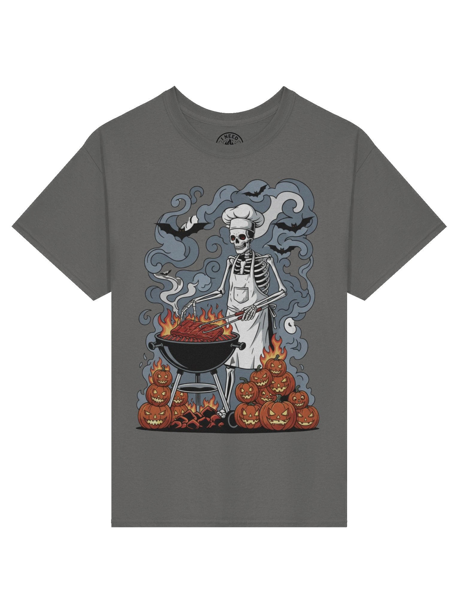 Skeleton Pitmaster tee: a skeleton in an apron flipping ribs over a kettle grill beside stacked jack-o'-lanterns