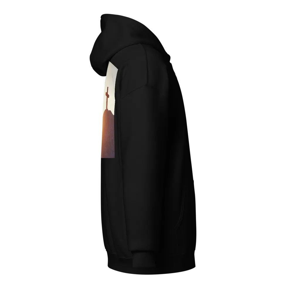 A cross placed on top of a rocky hill, bathed in the warm glow of a sunrise or sunset Hoodie product image (4)