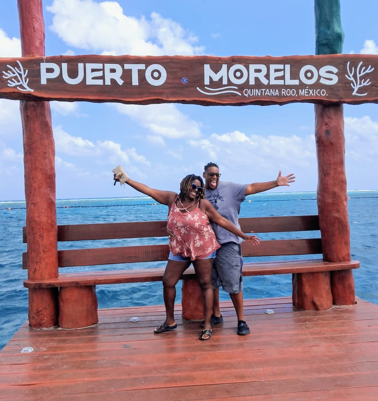 Dayna and her wife at the Puerto Morelos sign