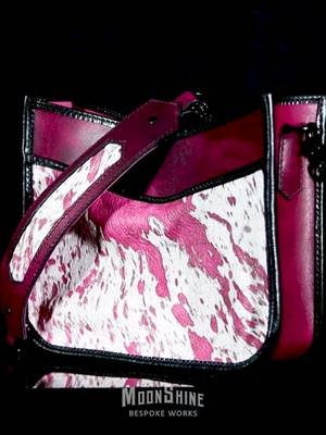 The latest from my table! One of a kind acid-washed hair-on hide on SB Foot Poppy in Razzle Dazzle, both from Springfield Leather Company. Black glazed goat edge binding, black hardware, and lined in pink pig suede. This one made me work for it, requiring that I tear it apart no less than three times to get everything lined up correctly. Worth it? I think so. 12