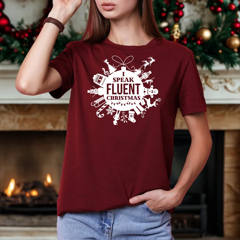 This image shows a model wearing a t-shirt that says, "I speak fluent Christmas" with a custom graphic.