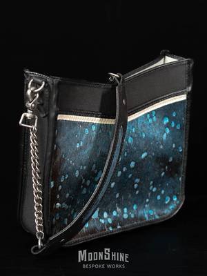 Finally got around to taking pictures of the latest bag from the workbench. This one features blue metallic acid washed hair on hide, a peekaboo of pearl, and antiqued nickel hardware on a haircell black SB Foot main body lined in gray suede. Check it out on my website!  #ooak#handmade #leather #bespoke #cowhide #acidwash #unique #fyp #leatherwork #handbag #purse #wehavepurse #moonshinebespokeworks