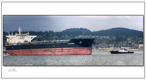 Crowley’s Tug Valor spinning the tanker California at Anacortes — that massive rust-streaked red hull filling the frame. Anot...