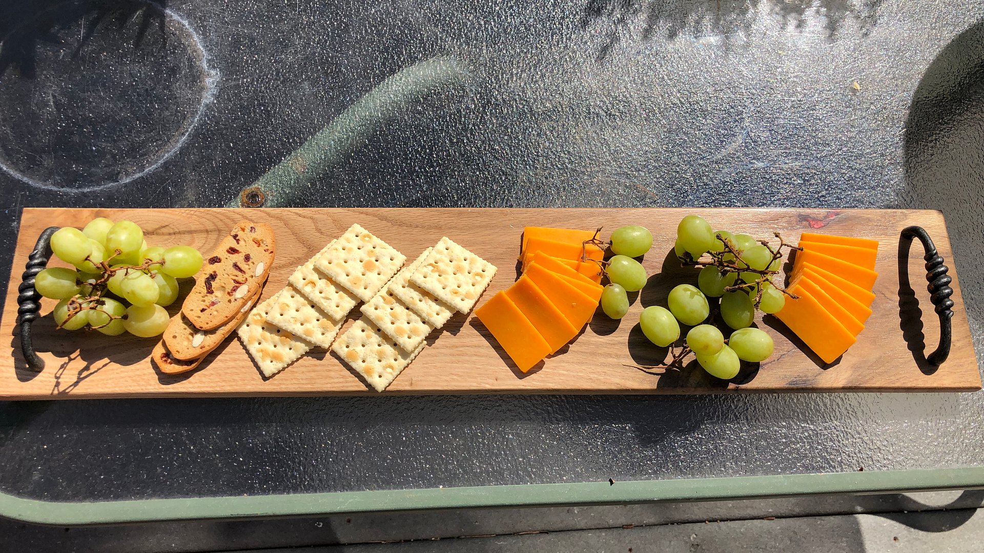 Knotty oak wood and wine red resin charcuterie board,cheese board, 5 1/2" x 27" x 5/8", with 4" twisted black handles. product image (6)