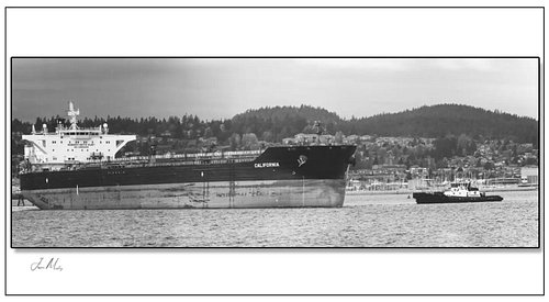 Tug Valor working an escort in Guemes Channel — Mt. Baker absolutely dominating the sky behind her in sepia. Small tug, big m...