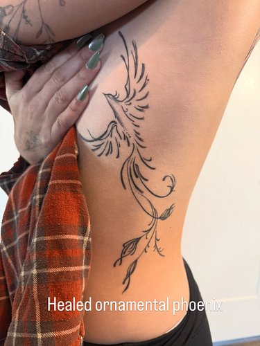 Healed ornamental phoenix tattoo on the ribs and fine line florals and script to add to an existing back tattoo (not my me). ...
