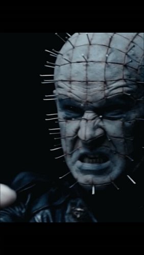 Bound by chains, a prisoner in fog. The armored figure, a vision of torment. Chains swirl, hooks gleam. A face of nails, a me...