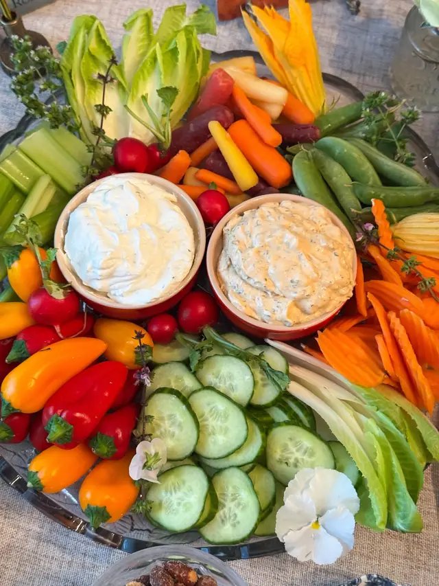 This Summer Harvest Veggie Tray seen at my Hamilton party is full of snack peppers, sugar snap peas, celery, endive leaves, rainbow carrots, sliced cucumber, radishes, and more. Grocery partner: @Kroger. We were really tasting the rainbow with this one!! 🌹 I included French onion dip and chipotle ranch dip for dippin’ and tucked some oregano flowers, Thai basil flowers, pansies, and zucchini blossoms from my garden around the platter for garnish. So pretty! I love how this veggie tray turned out. 😊🥒🌶️ #eatyourveggies #veggietray #vegetables #veggieboard #partyfood 