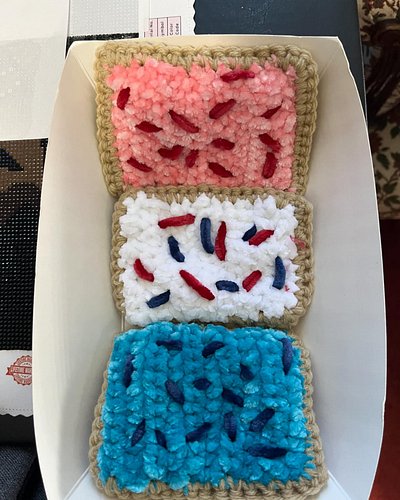 Did you guess breakfast pastry crinkle fidget toy?

These three beauties have some crinkle paper inside and two types of yarn...