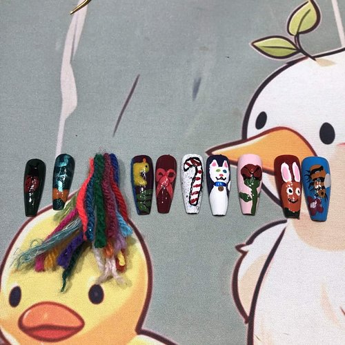 The nails that twitch chat had me paint in preparation of me wearing them tomorrow while Crocheting a Hedgehog on stream tomo...