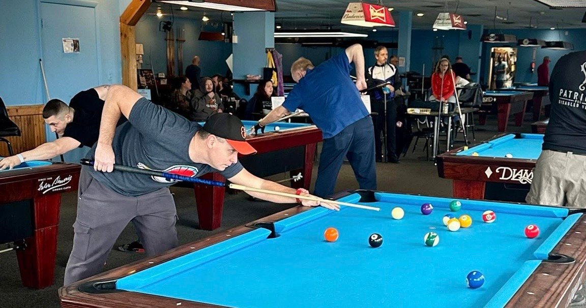 Check My Rack pool tournament with multiple players competing throughout a busy pool room