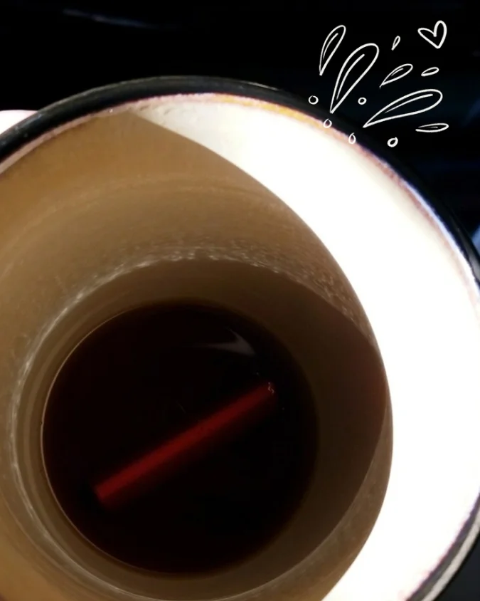 Photo of a crayon in Bri's coffee cup with a splashing doodle