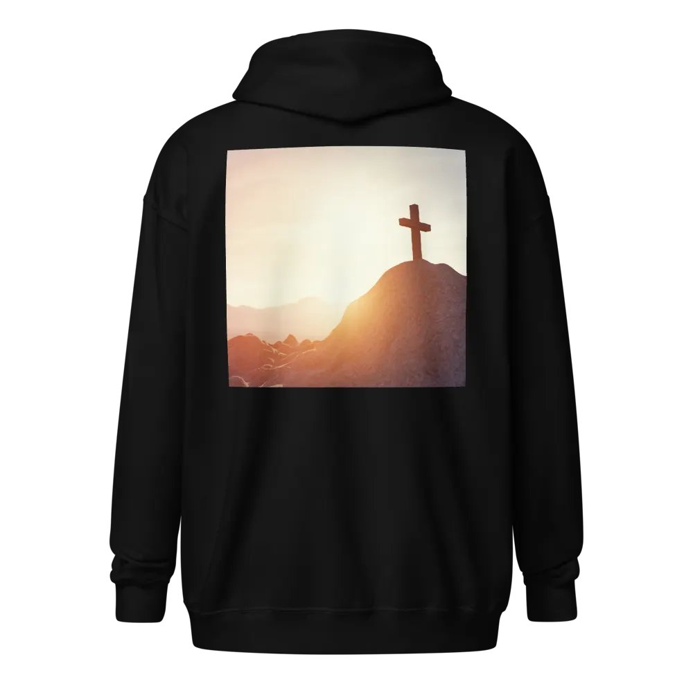 A cross placed on top of a rocky hill, bathed in the warm glow of a sunrise or sunset Hoodie product image (1)