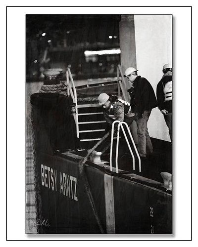 Lines tight, tug crew at work.  Aboard a bunker barges in the Port of Seattle—where every move is measured and every shift ke...