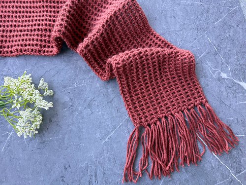 This one-stitch crochet scarf for men builds a handsome, pebbled texture from an easy repeat, finished with long relaxed frin...