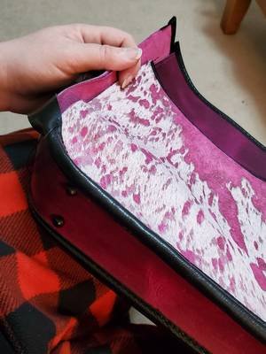 Each stitch painstakingly done by hand. Saddle stitching takes time, edge binding takes time, going through eight layers of leather takes time. All of my projects are sewn by hand, every time. If only it went this fast! Leathers here include SB Foot Poppy Razzle Dazzle and a unique acid wash hair-on-hide from @Springfield Leather Co.  #leathergoods #ooak #custom #leatherwork #handmade #moonshinebespokeworks #slcliveshopping #bespoke #handbag #purse #saddlestich #handsewn #sewing 