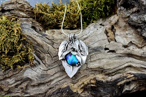 Dichroic glass set in sterling silver. The leaves are as close to natural as you can get. You really can't top Mother Nature.
