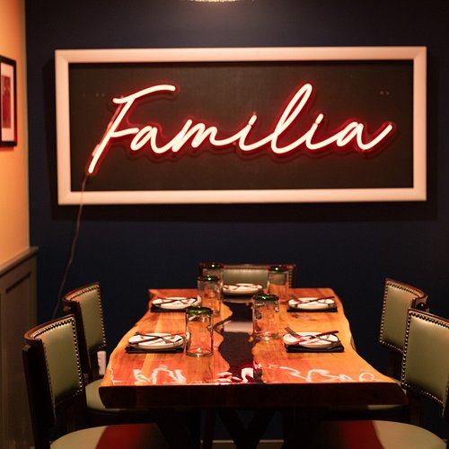Our Familia Room is perfect for intimate dining, secluded in the nook of our Bar and Lounge.  The Live Edge Table seats 4 - 6...