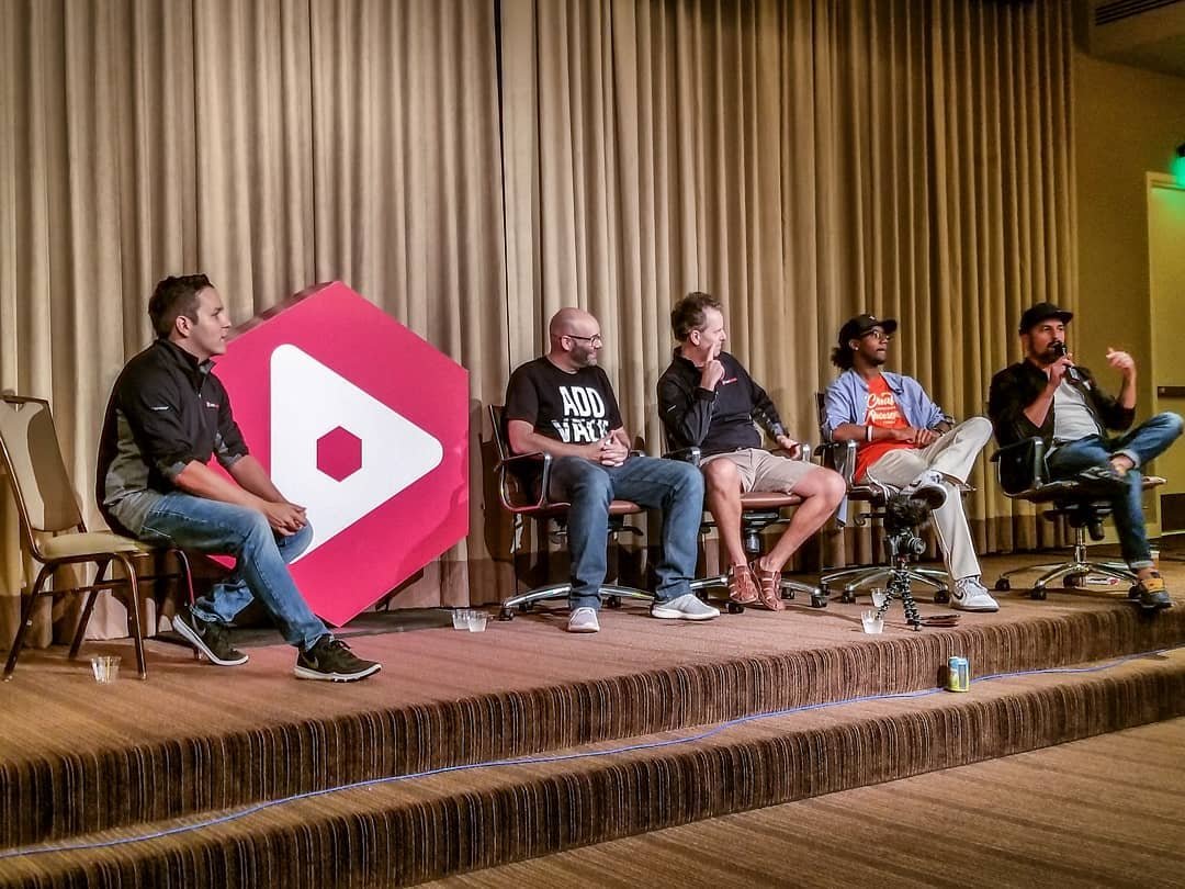 Andrew Kan hosting a YouTube creator panel on stage at VidSummit