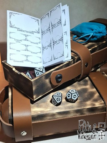 Your dice deserve better than rattling around loose in the bottom of your bag.

These wooden dice boxes have leather straps f...