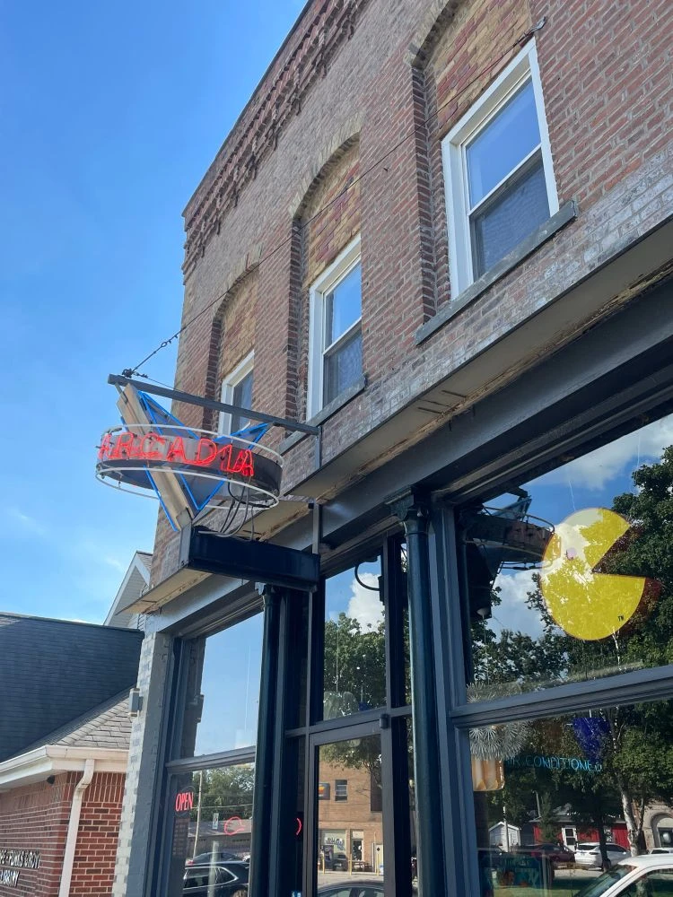 The storefront to ARcardia features a neon sign that juts out