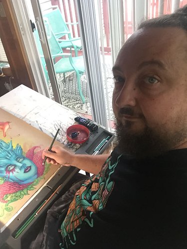 A pic of me at my old art desk, using Prismacolor soft core pencils on craft paper.