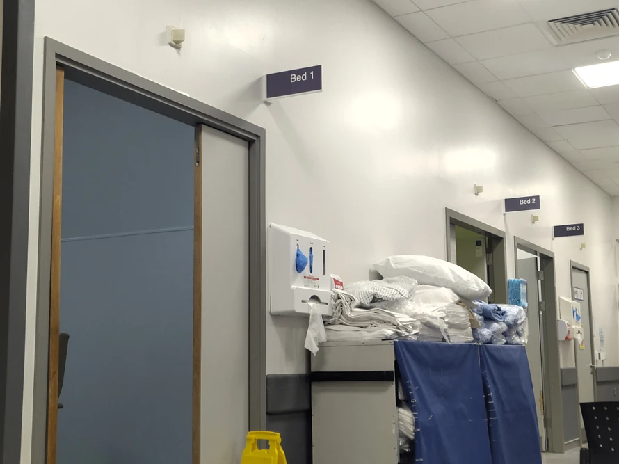The inside of a hospital, doors and bedding is shown