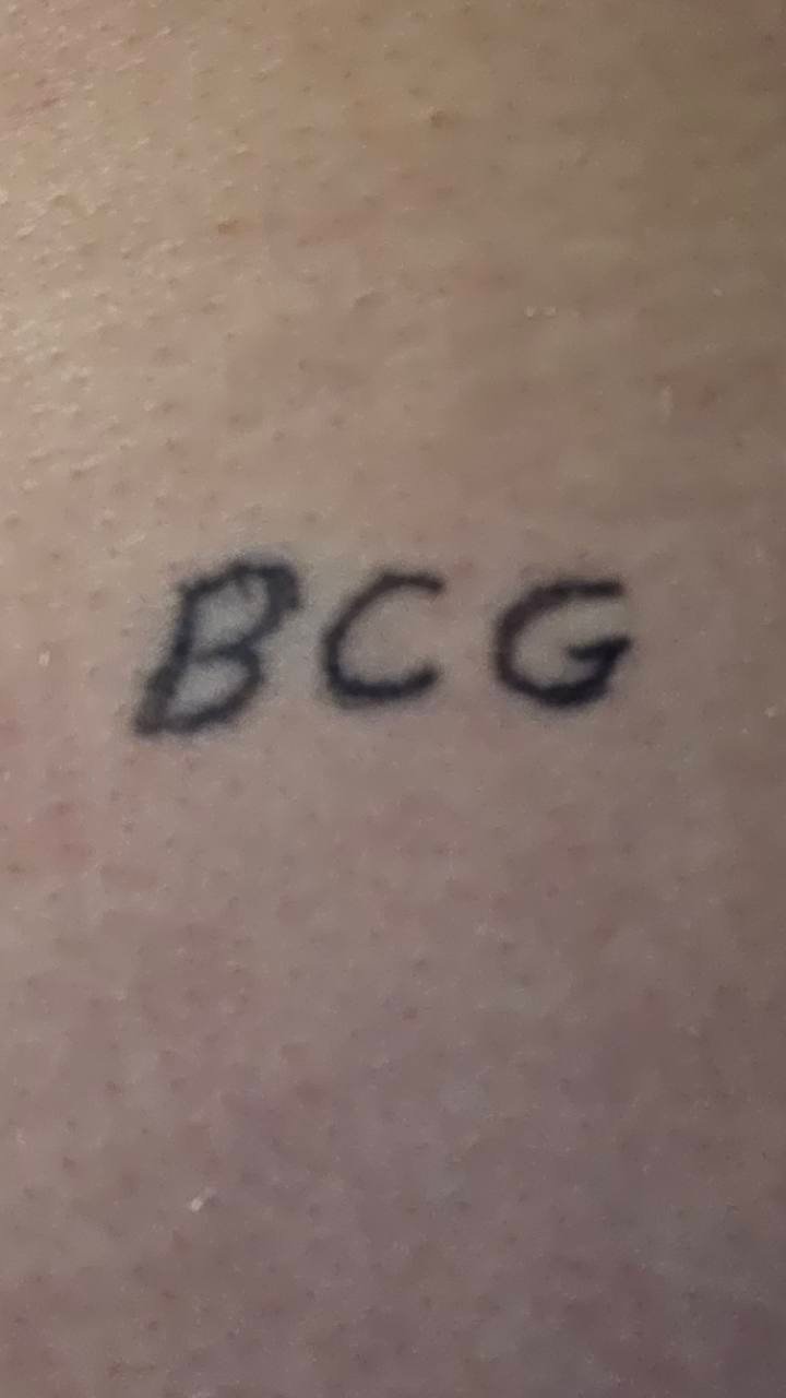 Close-up of greenbaykill’s original handwritten BCG tattoo