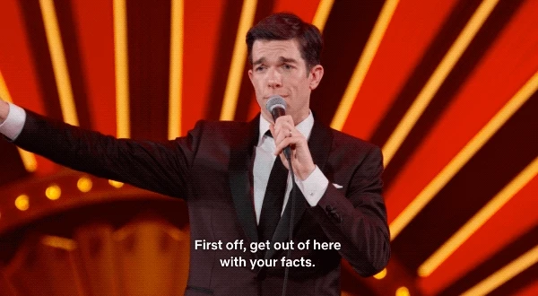 GIF of John Mulaney saying, “First off, get out of here with your facts.”