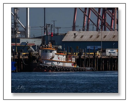 The Mary Catherine H. tied up at the fuel dock in Seattle — classic tug lines, orange rail trim, tire fenders, and those big ...