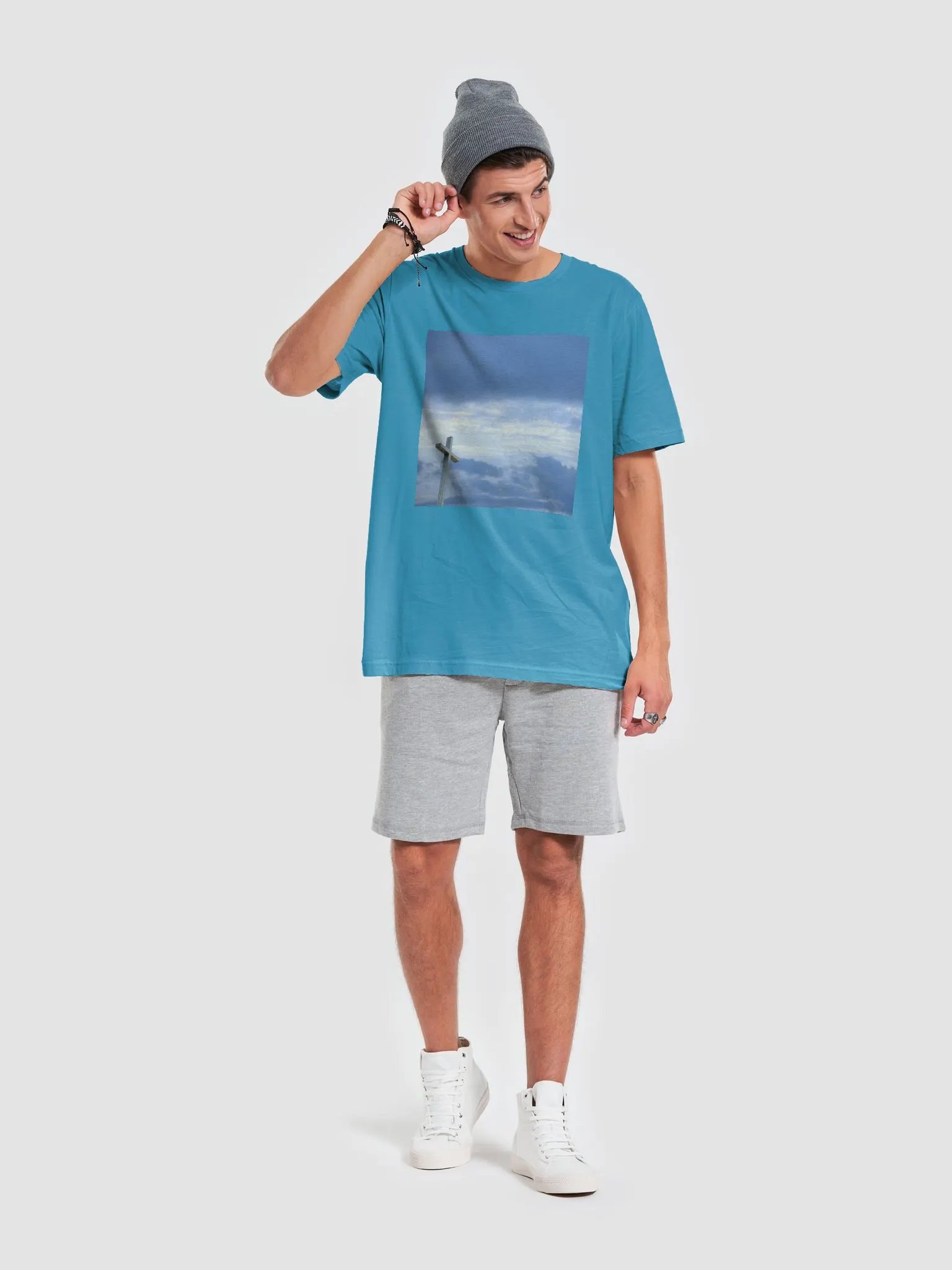 A cross standing against a dramatic sky with layers of clouds t-shirt product image (3)