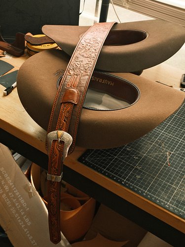 My cowboy hats were the safest place to put the new adjustable and fully tooled guitar strap I just finished. It’s 650 if any...