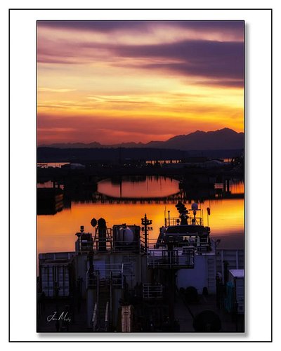 Tug Athena escorting the Todd E. Prophet out of Hylebos Waterway under a sunset that went completely unhinged — orange, purpl...