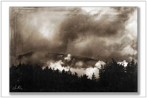 Storm clouds boiling over the mountains above Port Angeles — fog tearing through the tree line, the whole scene aged like a p...
