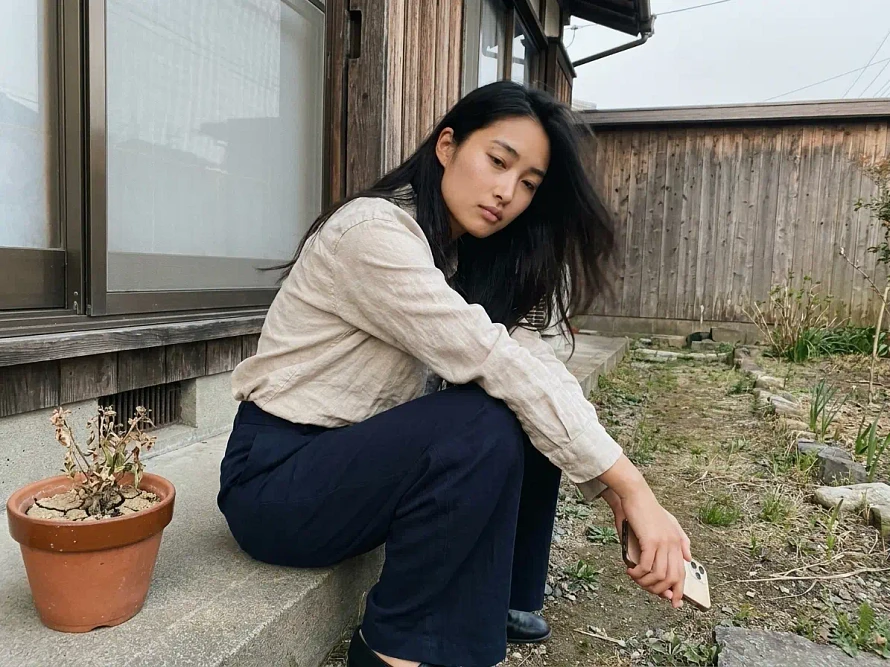 Woman sitting on back step