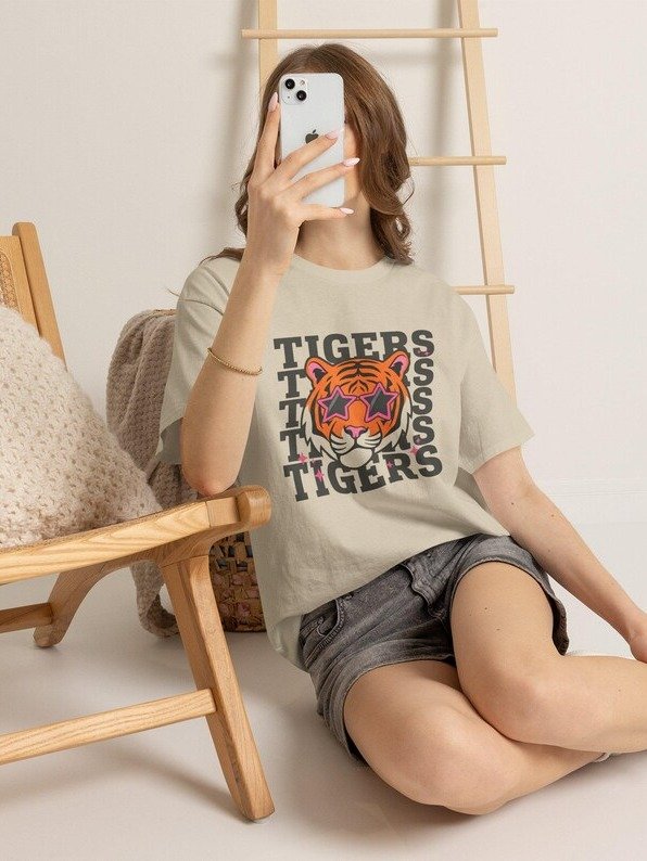 This lightweight cotton tee carries a cozy, spooky energy — a layered Halloween scene where a grinning jack-o’-lantern crowns a skeleton, bat wings unfurl behind, and playful ghosts and a haunted hous product image (90)