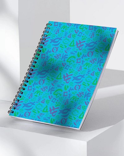 Same Autisymbols, different object — this time as an all-over pattern on a spiral notebook instead of a single graphic. I pai...