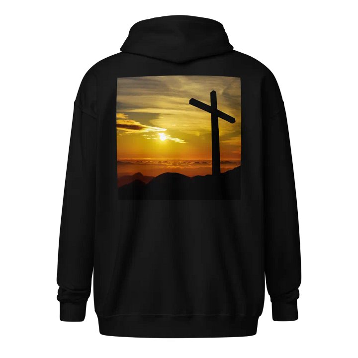 Large cross silhouetted against a dramatic sunset, vibrant hues of yellow, orange, dominate the sky, with clouds and distant mountains Hoodie product image (1)